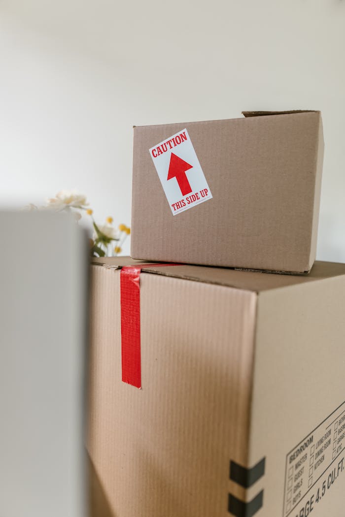 Cardboard boxes with caution labels in a bright indoor setting, ideal for moving themes.
